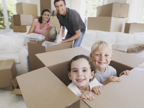 Organised moving boxes labelled for rooms in a West London property