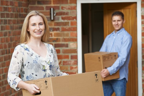 Packed moving boxes and furniture prepared for transport in Shepherds Bush