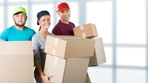 Removal team handling furniture and boxes during a local house move