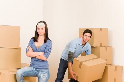 Furniture removals team handling a move in Shepherds Bush residential street
