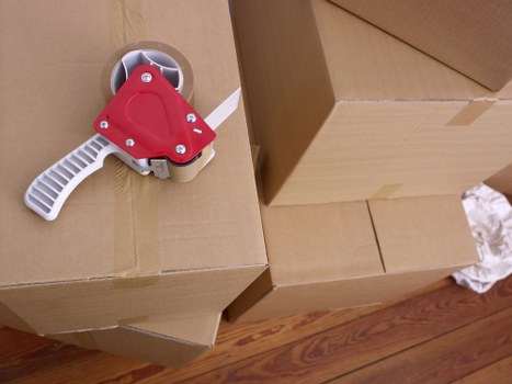 Careful wrapping of fragile household items during packing service